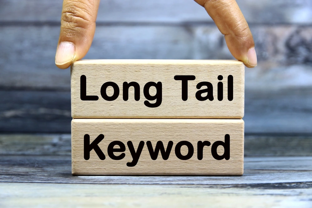 Small business owner researching long-tail keywords to improve SEO rankings and attract more customers